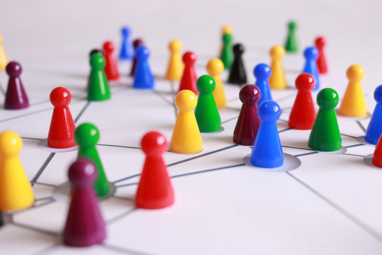 A group of colorful game pieces sit on a white board