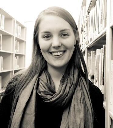 Black and white headshot of Nadia in a library