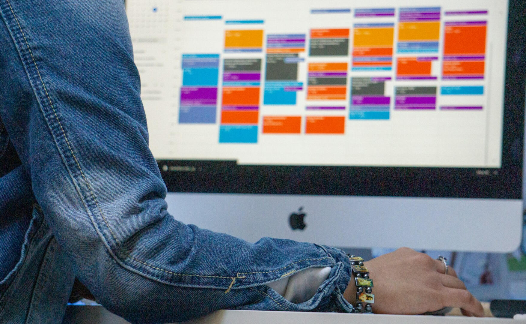 A woman in a jean jacket checks her online calendar app